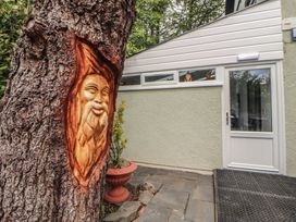 A tree with a carving and a door at Eden House Bardsea
