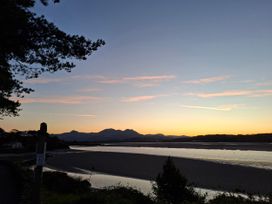 A view of mountains and water at sunset at Llannor in Borth-y-Gest