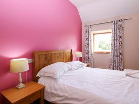 A bedroom with a bed and nightstand at Pottowe Cottage in Potto near Stokesley