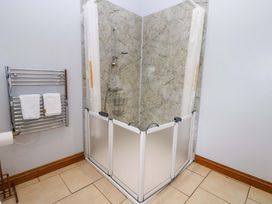 A shower area with towels on a rack at Pottowe Cottage, Potto near Stokesley