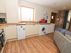 A kitchen with appliances and cabinets at Cooper Cottage in Potto near Stokesley