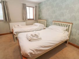 A bedroom with two single beds and a radiator at Cooper Cottage Potto near Stokesley