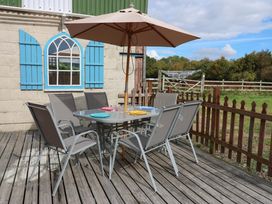 An outdoor seating area with a table and chairs at Cooper Cottage Potto near Stokesley