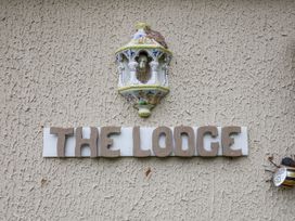 A sign that reads THE LODGE with a light fixture at The Lodge Old Buckenham near Attleborough