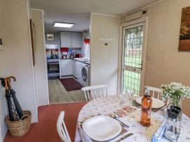 A dining room with a table set for a meal at The Lodge in Old Buckenham near Attleborough