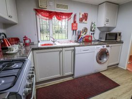 A kitchen with a sink and appliances at The Lodge in Old Buckenham near Attleborough
