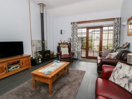 A living room with a fireplace and seating area at Yr Hen Llaethdy near Blaen-Cil-Llech near Newcastle Emlyn