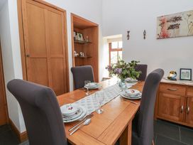 A dining room with a table set for a meal at Yr Hen Llaethdy near Blaen-Cil-Llech near Newcastle Emlyn
