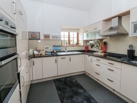 A kitchen with appliances and utensils at Yr Hen Llaethdy in Blaen-Cil-Llech near Newcastle Emlyn