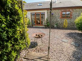 An outdoor area with a swing and fire pit at Yr Hen Llaethdy in Blaen-Cil-Llech near Newcastle Emlyn
