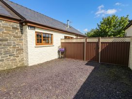 An outdoor photo of a house with a fenced yard at Yr Hen Llaethdy in Blaen-Cil-Llech near Newcastle Emlyn