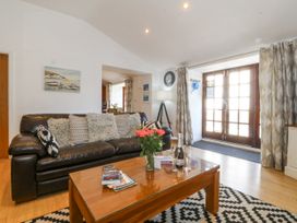 A living room with a sofa and coffee table at Maritime Mews, 6 The Oakleys, Porthmadog