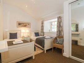 A bedroom with two beds and a window at Maritime Mews, 6 The Oakleys, Porthmadog