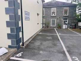 An outdoor parking area with marked spaces and a sign at Maritime Mews, 6 The Oakleys, Porthmadog