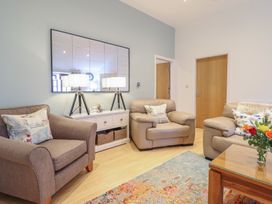 A living room with two sofas and a coffee table at Maritime Mews, 6 The Oakleys in Porthmadog