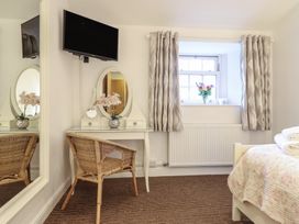 A bedroom with a bed, desk, and television at Maritime Mews, 6 The Oakleys, Porthmadog