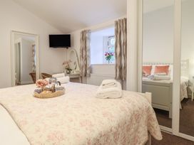 A bedroom with a bed and television at Maritime Mews, 6 The Oakleys in Porthmadog