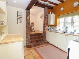 A kitchen with a sink and staircase at Sleepeezy in Little Snoring