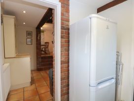 A kitchen with refrigerator and cabinets at Sleepeezy in Little Snoring