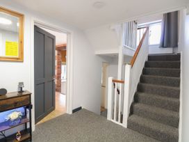 A hallway with a staircase and door at Sleepeezy in Little Snoring
