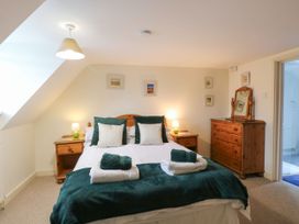 A bedroom with a bed and bedside lamp at Sleepeezy in Little Snoring