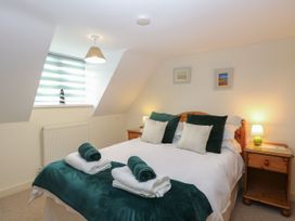 A bedroom with a double bed and nightstand at Sleepeezy in Little Snoring
