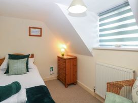 A bedroom with a bed and dresser at Sleepeezy in Little Snoring