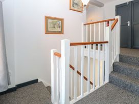 A staircase with carpet and framed pictures at Sleepeezy in Little Snoring