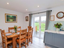 A dining room with a table and chairs at Berry Banks Cottage in Whitby