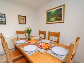 A dining room with a table set for a meal at Berry Banks Cottage in Whitby
