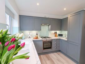 A kitchen with cabinets and appliances at Berry Banks Cottage in Whitby