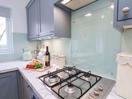A kitchen with a gas stove and various kitchen items at Berry Banks Cottage in Whitby