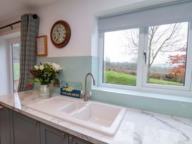 A kitchen with a sink and window at Berry Banks Cottage in Whitby