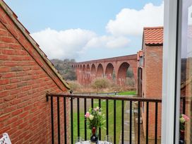 A balcony view of a viaduct and garden at Berry Banks Cottage in Whitby