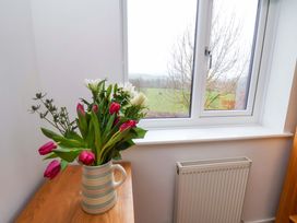 A vase with flowers on a windowsill at Berry Banks Cottage, Whitby