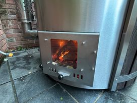 A wood burner with fire visible at Treetops in Southerton near Sidmouth