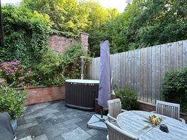 A garden with a hot tub and seating area at Treetops in Southerton near Sidmouth