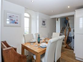 A dining room with a table set for dinner at Eglwys St Cynfil Penrhos near Pwllheli