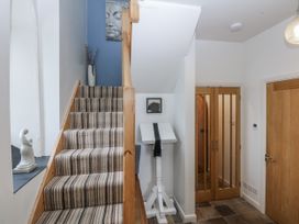 A hallway with stairs and a sculpture at Eglwys St Cynfil Penrhos near Pwllheli