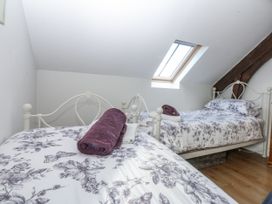 A bedroom with two beds and towels at Eglwys St Cynfil Penrhos near Pwllheli