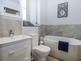 A bathroom with a sink toilet and bathtub at Eglwys St Cynfil Penrhos near Pwllheli