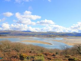 A river estuary with sandbanks and hills in the background at Bryn Eithin in Borth-y-Gest near Porthmadog