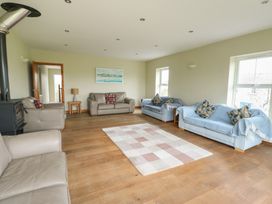 A living room with sofas and a lamp at Chapel House Elim near Llanddeusant