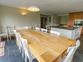 A dining room with a large table and chairs at Chapel House Elim near Llanddeusant