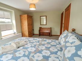 A bedroom with a bed and a wardrobe at Chapel House Elim near Llanddeusant