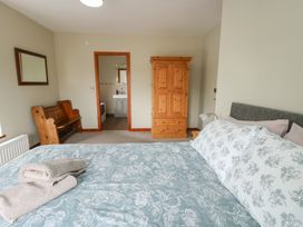 A bedroom with a bed and wardrobe at Chapel House Elim near Llanddeusant