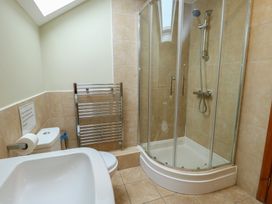A bathroom with a shower enclosure and toilet at Chapel House Elim near Llanddeusant