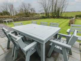 A garden with a table and chairs at Chapel House Elim near Llanddeusant
