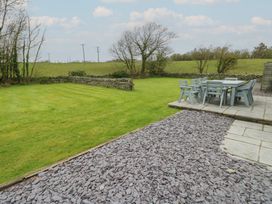 A garden with a patio and seating area at Chapel House Elim near Llanddeusant