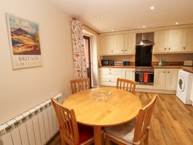 A kitchen with a dining table and chairs at The Old Bothy Bolton Low Houses near Wigton